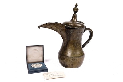 Lot 928 - A bronze Islamic dallah coffee pot, given as a gift by the Crown Prince of Jordan 1992