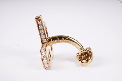 Lot 1134 - Jacob & Co, New York: a pair of diamond-set yellow gold monogram pattern cufflinks