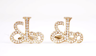 Lot 1134 - Jacob & Co, New York: a pair of diamond-set yellow gold monogram pattern cufflinks