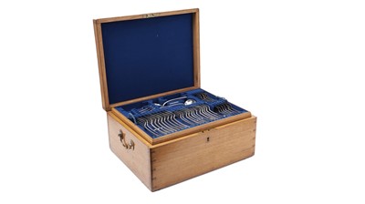 Lot 443 - A canteen of flatware and cutlery in a fitted oak case; with two matching basting spoons