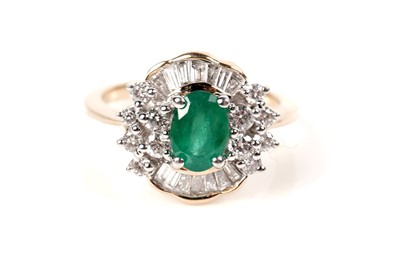 Lot 1165 - An emerald and diamond cluster ring