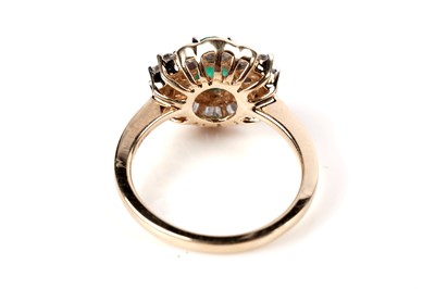 Lot 1165 - An emerald and diamond cluster ring