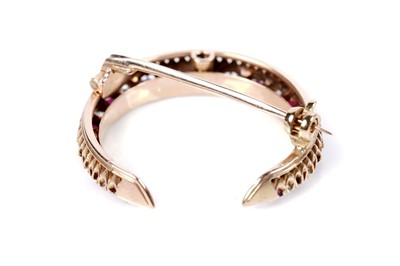 Lot 1172 - A ruby and diamond crescent brooch