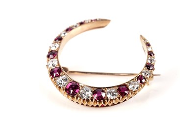 Lot 1172 - A ruby and diamond crescent brooch