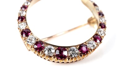 Lot 1172 - A ruby and diamond crescent brooch