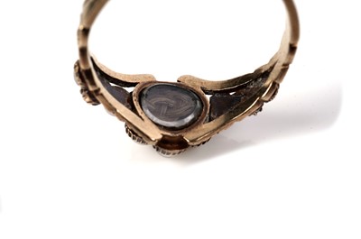 Lot 1125 - A Victorian ruby and seed pearl mourning ring