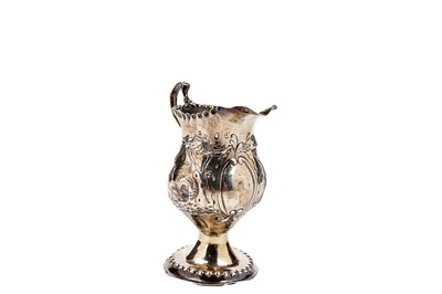 Lot 1453 - A George III embossed cream jug and another late Victorian jug