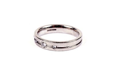 Lot 561 - A diamond and 18ct white gold wedding band