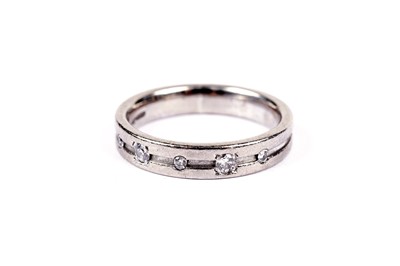 Lot 561 - A diamond and 18ct white gold wedding band