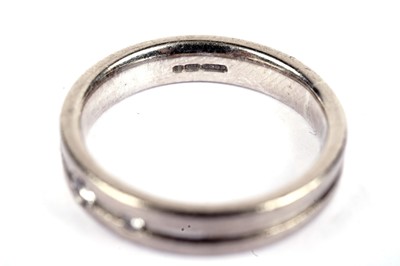 Lot 561 - A diamond and 18ct white gold wedding band