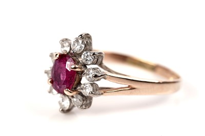 Lot 1194 - A ruby and diamond cluster ring
