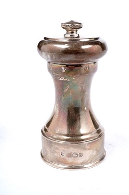 Lot 1339 - An Elizabeth II tea strainer and a peppermill