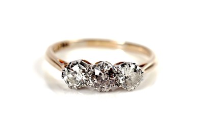 Lot 1151 - A three stone diamond ring