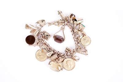 Lot 569 - A gold charm bracelet