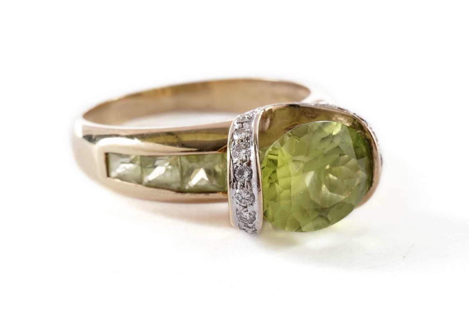 Lot 55 - A peridot and diamond dress ring