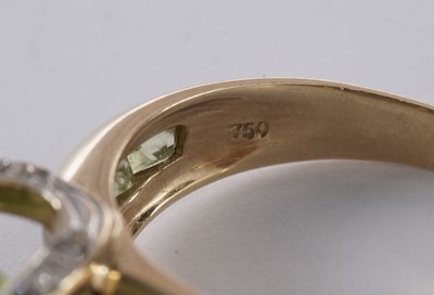 Lot 55 - A peridot and diamond dress ring