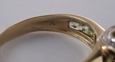 Lot 55 - A peridot and diamond dress ring