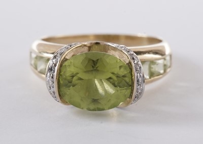 Lot 55 - A peridot and diamond dress ring