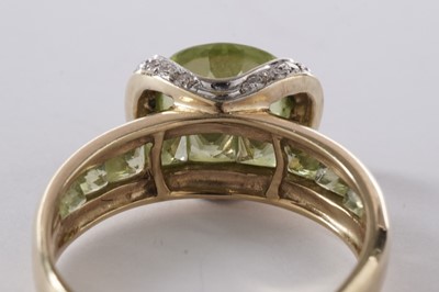 Lot 55 - A peridot and diamond dress ring