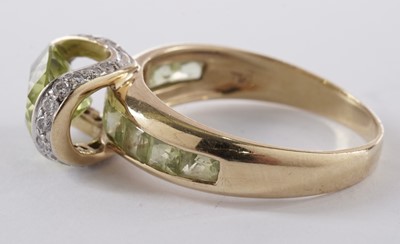 Lot 55 - A peridot and diamond dress ring