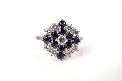 Lot 51 - A sapphire and diamond cluster ring