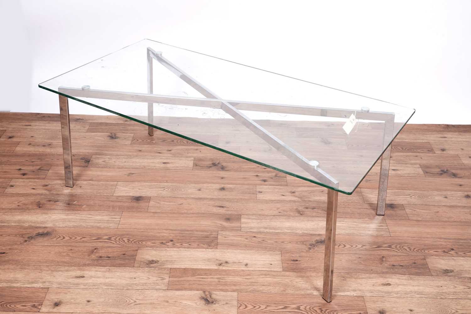 Lot 12 - A Barcelona style chrome and glass coffee table