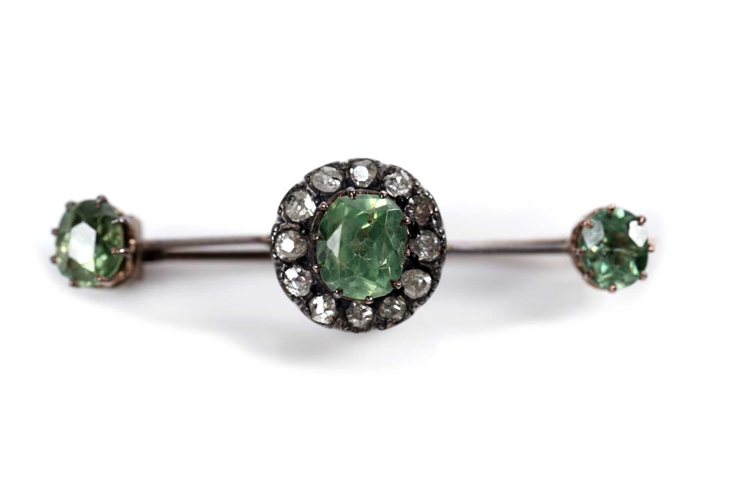 Lot 1117 - A Victorian peridot and diamond cluster bar brooch