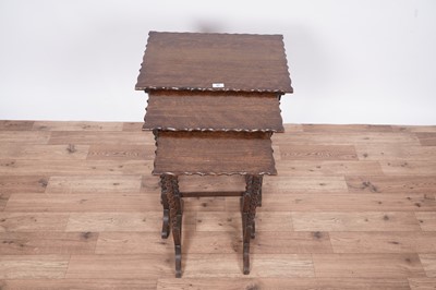 Lot 27 - An early 20th Century oak nest of three tables