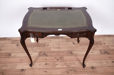 Lot 7 - An Edwardian style serpentine fronted writing desk