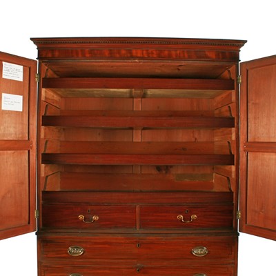 Lot 77 - A late George III mahogany tray wardrobe or press