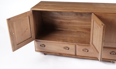 Lot 818 - An Ercol elm and beech dining room suite