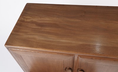 Lot 818 - An Ercol elm and beech dining room suite