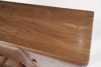Lot 818 - An Ercol elm and beech dining room suite