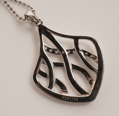 Lot 41 - An openwork cubic zirconia set silver pendant on chain
