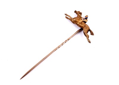 Lot 19 - A yellow metal horse and jockey stick pin