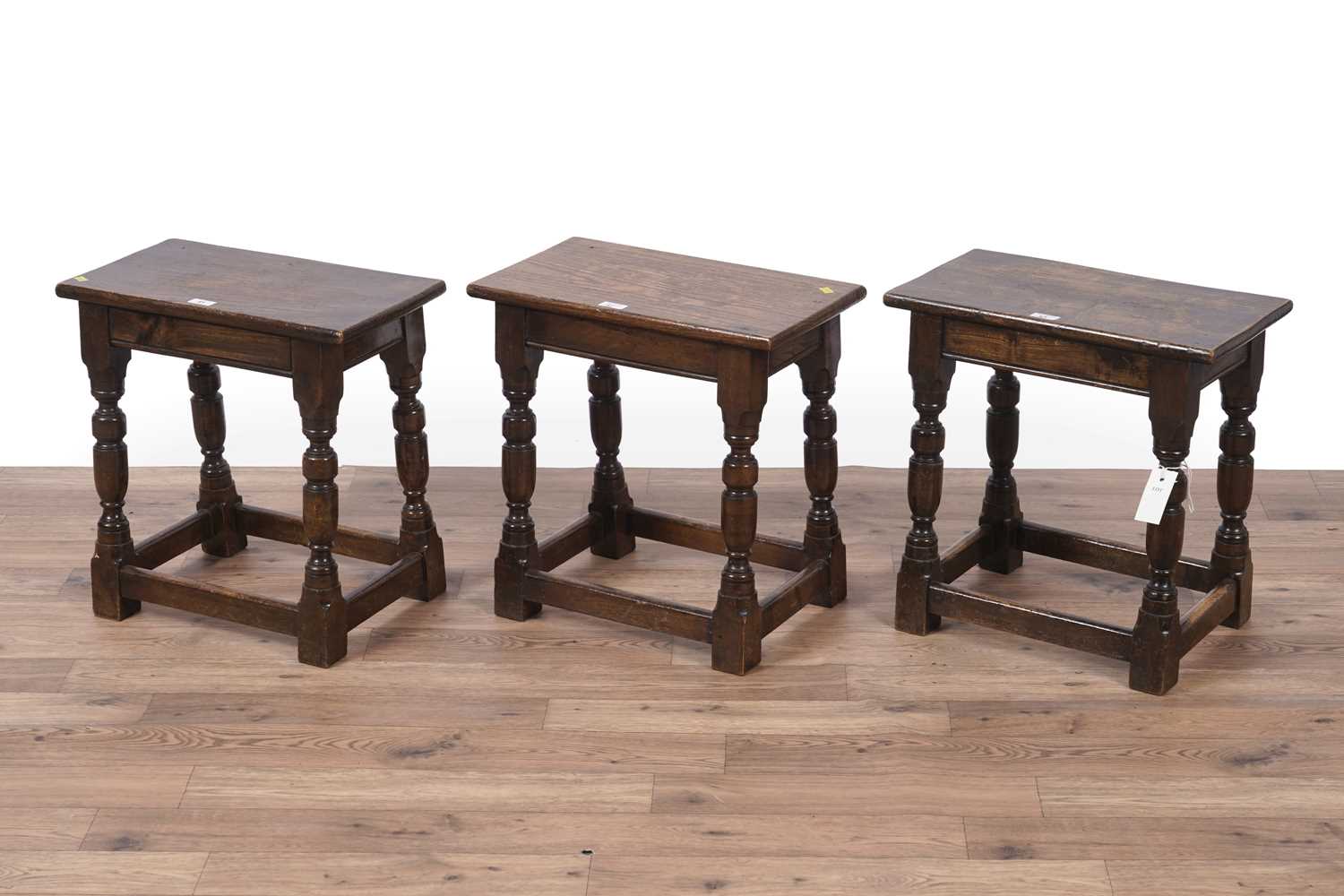 Lot 41 - A set of three Jacobean style set of three oak stools
