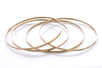 Lot 11 - A set of four 9ct yellow gold bangles