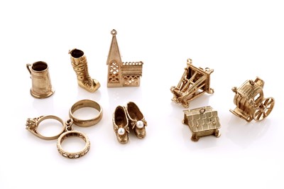 Lot 20 - A collection of 9ct yellow gold charms; with a gilt metal charm