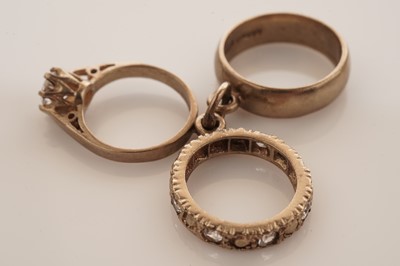 Lot 20 - A collection of 9ct yellow gold charms; with a gilt metal charm