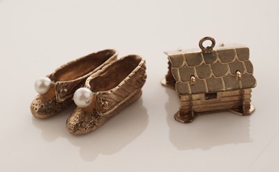 Lot 20 - A collection of 9ct yellow gold charms; with a gilt metal charm