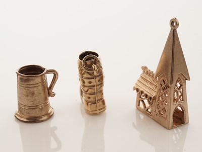 Lot 20 - A collection of 9ct yellow gold charms; with a gilt metal charm