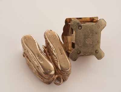 Lot 20 - A collection of 9ct yellow gold charms; with a gilt metal charm