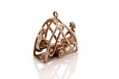 Lot 17 - A 9ct gold seesaw pendant