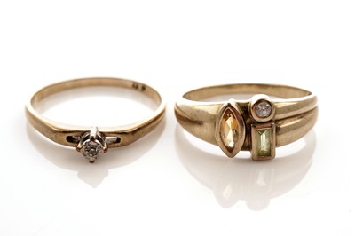 Lot 26 - A coloured gemstone set ring; and a solitaire diamond ring