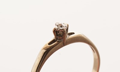 Lot 26 - A coloured gemstone set ring; and a solitaire diamond ring
