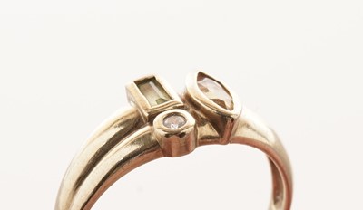Lot 26 - A coloured gemstone set ring; and a solitaire diamond ring