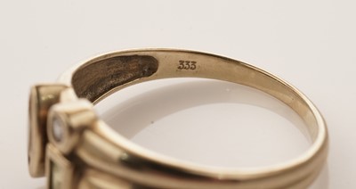 Lot 26 - A coloured gemstone set ring; and a solitaire diamond ring