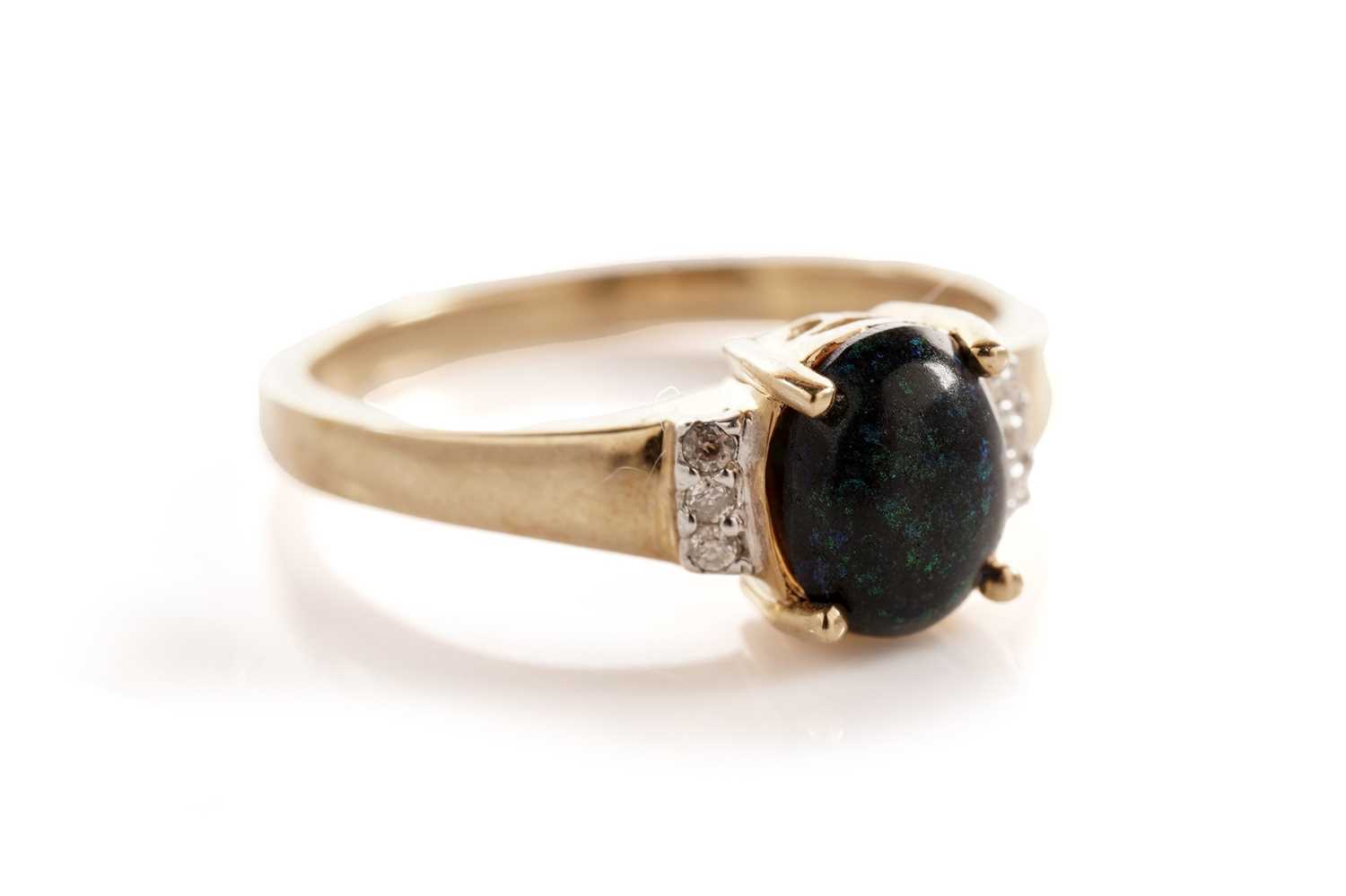 Lot 106 - A black boulder opal and diamond ring