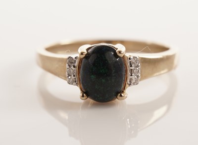 Lot 106 - A black boulder opal and diamond ring
