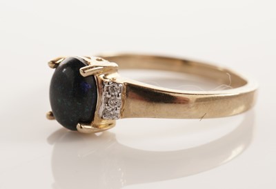 Lot 106 - A black boulder opal and diamond ring